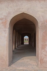 Fototapeta na wymiar symmetrical exterior corridor with arches and columns in the Serai Nurmahal , Historical Monument , Punjab, India