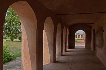 Fototapeta na wymiar symmetrical exterior corridor with arches and columns in the Serai Nurmahal , Historical Monument , Punjab, India