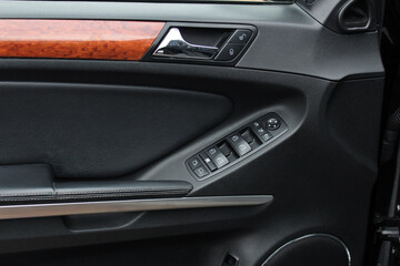 Fototapeta na wymiar Car door trim, door handle and control buttons.