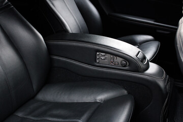 Black leather passenger seat in modern lux car. Black leather car passenger seat. Car leather seats.