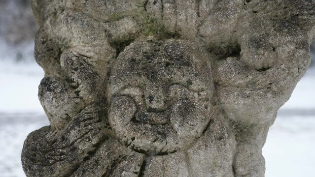 The face of an ancient, stone Slavic idol in Ukraine in winter