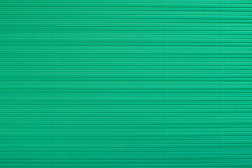 Green corrugated cardboard background.