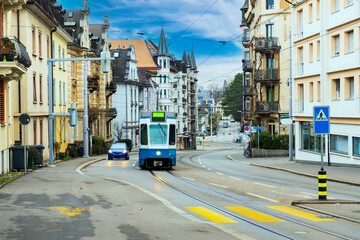 Colorful houses with blue winter sky in Zurich, Switzerland. Ancient street with tram way road.Traditional Swiss houses in the old town village.Tram way on street. Tram station.