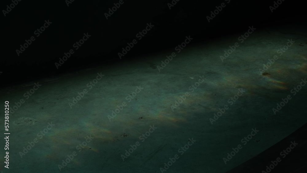 Poster light refracted through water surface creating rainbow effect at the bottom. underwater