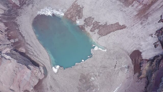 The blue lake in the crater of Gorely volcano. Kamchatka Peninsula, Russia
