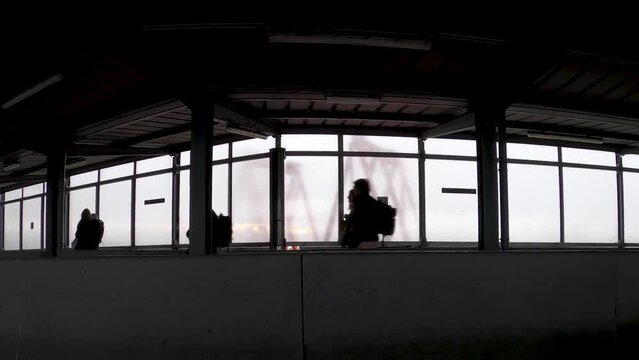 Passengers silhouette walking in departure hall of vintage airport building -  Cinematic time lapse