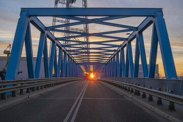 rising sun over the truss bridge