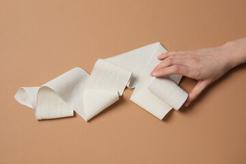 Help during an injury, female hand holds elastic bandage