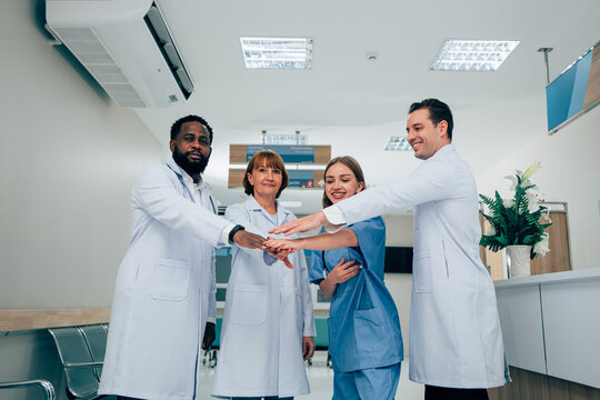 Team of Mature Male Doctor and Female doctor Standing in Hospital Corridor. Concept Of Medical Technology and Healthcare Business.