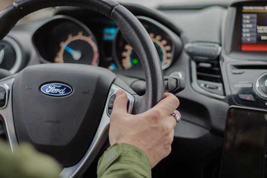 Ukraine - 01.26.2023: Man driving car Ford Fiesta. Auto interior. Man hand on steering wheel. Auto dashboard. Journey concept. Personal transport. Inside the car. Speed background. Driver in car. 