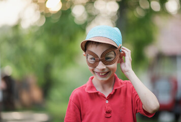 child standing outside and posing, a portrait of a boy