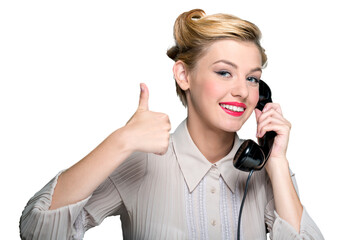 Attractive young woman speaking on  vintage phone with thumb up