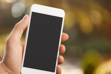 Hands hold a phone with a blank screen