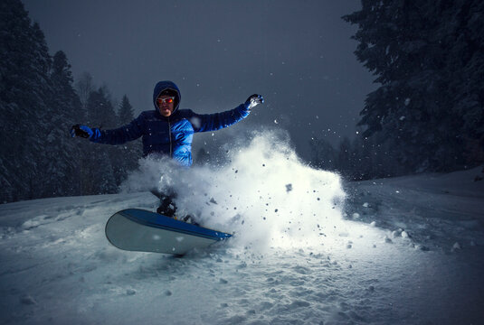 Snowboarder in action lit by strobe