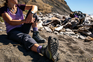 Female hiker resting on beach, Lost Coast Trail, Kings Range National Conservation Area, California, USA