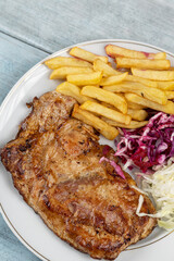 Meat stuffed with cheese and served with french fries and salad