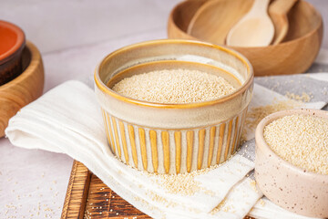 Bowls of amaranth seeds on table, closeup