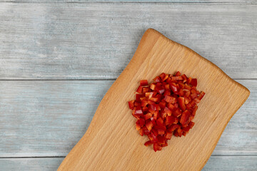 Chopped red paprika on the wooden board