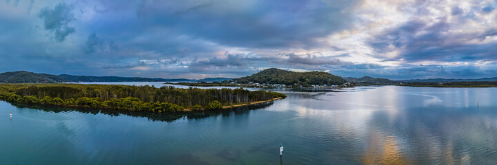 Fototapeta na wymiar After the rain sunrise panorama waterscape with clouds