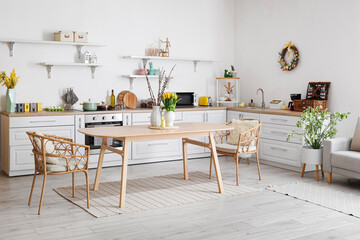 Interior of kitchen with Easter decor, white counters and dining table