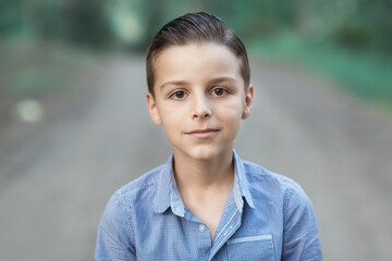 child standing outside and posing, a portrait of a boy