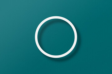 paper cut into circle shape with light and shadow placed on a green paper background