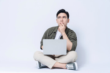 Young Asian business man sitting and using laptop on background