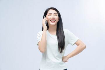 Young Asian girl using smartphone on background