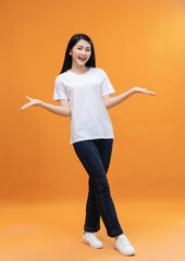 Fototapeta na wymiar Full length image of young Asian girl on background