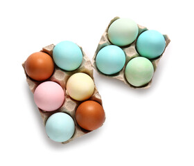 Cardboard holders with painted Easter eggs on white background