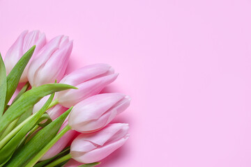 Bouquet of beautiful tulip flowers on pink background. Women's Day celebration