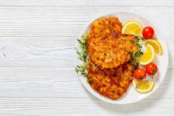 fried breaded chicken breast cutlets on plate