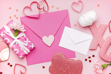 Composition with tasty cookies, envelopes and gift for Valentine's Day celebration on pink background, closeup