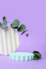 Podiums with eucalyptus branches on lilac background. Hello spring