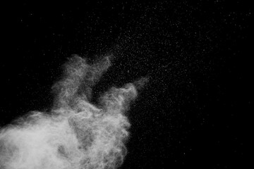 White powder explosion isolated on black background.White dust particles splash.