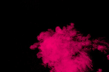 Pink powder explosion on black background.Pink dust splash cloud on dark background.