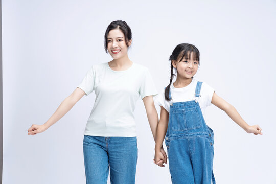 Image of Asian mother and daughter on background