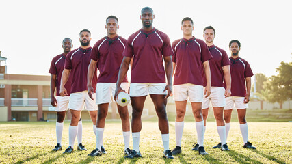 Rugby, black man and strong team portrait on field, solidarity and confidence for winning game. Diversity, leadership and teamwork, group of strong sports people standing together in power on grass.