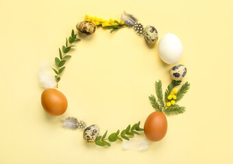 Naklejka na ściany i meble Frame made of Easter eggs, mimosa flowers and eucalyptus branches on yellow background