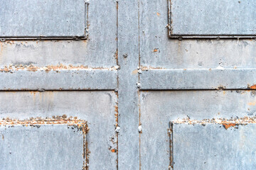 sheet metal texture. welded metal door made of several sheets of iron. iron door texture closeup