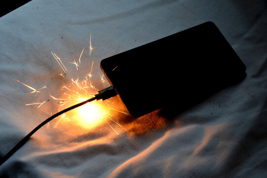 Cell phone battery failure. A smartphone can quickly catch fire set fire, night house, apartment, or car. there is a risk of burns to the device user. flames surround entire tablet, laptop, computer