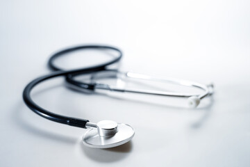 Stethoscope on a light gray background, medical diagnostic device for heart, lungs or digestive tract, copy space, selected focus