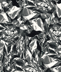 Crumpled aluminum foil 
 background close up in high resolution.