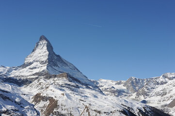 Matterhorn mountain peak  in Alps in winter with snow and clear blue sky in Cervinia, Italy and Zermatt, Switzerland. Beautiful and magnificent landscape on a sunny day