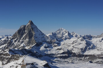 Fototapeta na wymiar Matterhorn mountain peak in Alps in winter with snow and clear blue sky in Cervinia, Italy and Zermatt, Switzerland. Beautiful and magnificent landscape on a sunny day