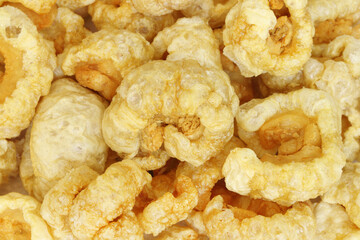 Closeup of pork snack or pork rinds, deep fried pork skin and blistered is traditional food in the north of Thailand.