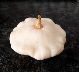 White squash patisson isolated on dark background. High quality photo
