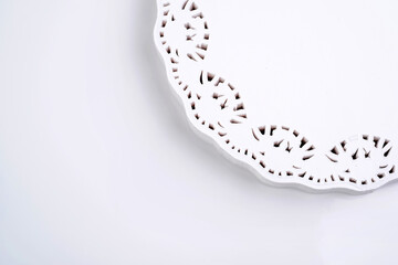 Round white lacy napkin isolated on white background, copy space. Clipping path - obrazy, fototapety, plakaty