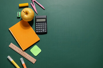 Composition with different stationery and apple on blackboard. Pi Day celebration