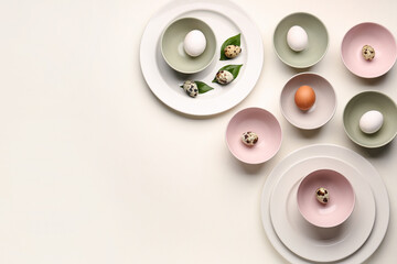 Composition with set of plates, bowls and Easter eggs on white background